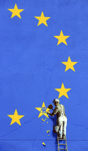 A view of a mural by artist Banksy of a workman removing a star from the EU flag in Dover England on Monday May 8