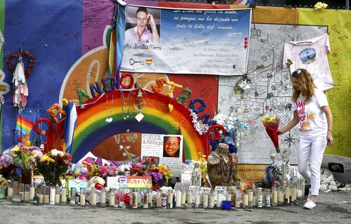 Pulse nightclub owner Barbara Poma tends to the memorial in front of her club Saturday