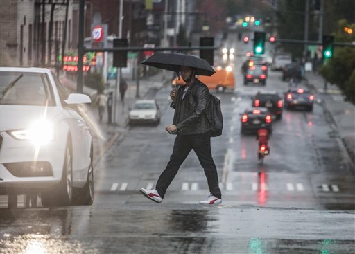 A man walks in the intersection along 15th Ave. NE near the University of Washington campus Thursday