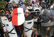 White nationalist demonstrators use shields as they guard the entrance to Lee Park in Charlottesville