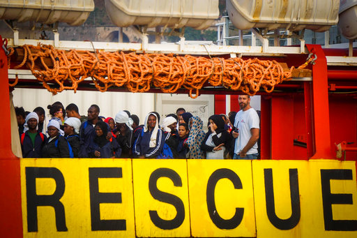 Migrants wait to disembark from the NGO (Non-government organization) Medecins Sans Frontier Vos Prudence ship after being rescued at sea