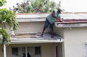 A homeowner makes last minute repairs to his roof in preparation for Hurricane Irma