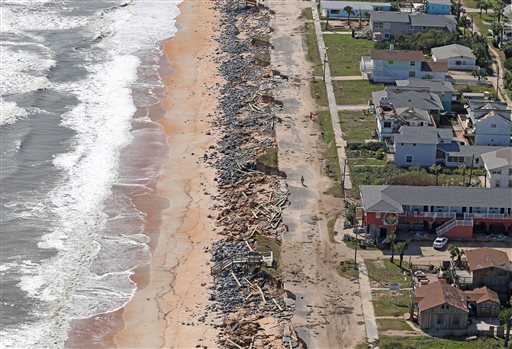 Debris lies on a portion of the damaged A1A Highway which was closed in Flagler Beach