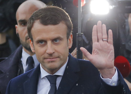 Independent centrist presidential candidate Emmanuel Macron makes a sign to bystanders as he leaves the Holocaust memorial in Paris