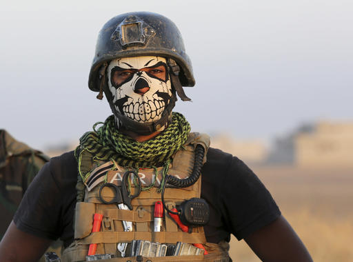 A member of Iraq's elite counterterrorism forces pauses as they advance towards the city of Mosul