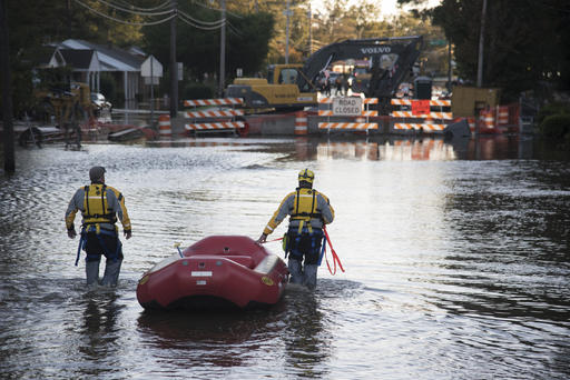 A swift water rescue team down a street covered by floodwaters caused by rain from Hurricane Matthew in Lumberton
