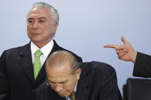 CORRECTS YEAR - Brazil's President Michel Temer stands behind Chief of Staff Eliseu Padilha during a ceremony marking World Environment Day