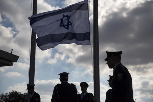 Members of the Knesset guard stand next to the Israeli flag at half-staff in preparations to display the coffin of former Israeli President Shimon Peres at the Knesset
