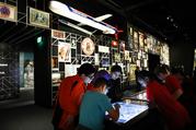 A school groups explores an interactive touch table to learn about the objects and images on display at the "Americans" exhibit at the Smithsonian's National Museum of the American Indian