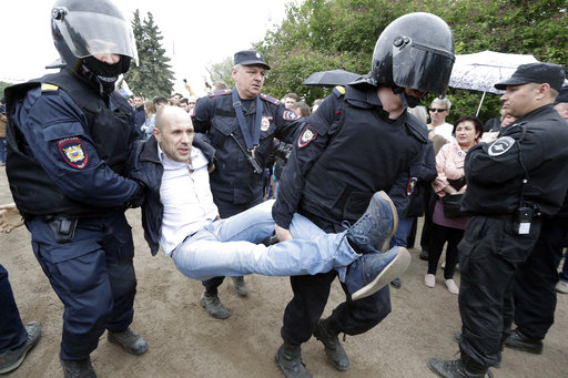 Police detain a protester during anti corruption rally in St.Petersburg
