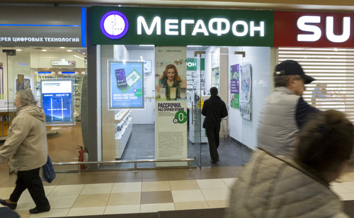 People walk past a Megafon mobile phones shop in Moscow