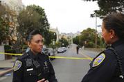 San Francisco Police Officer Grace Gatpandan speaks with another officer as they respond to reports of a shooting at Dolores Park in San Francisco on Thursday