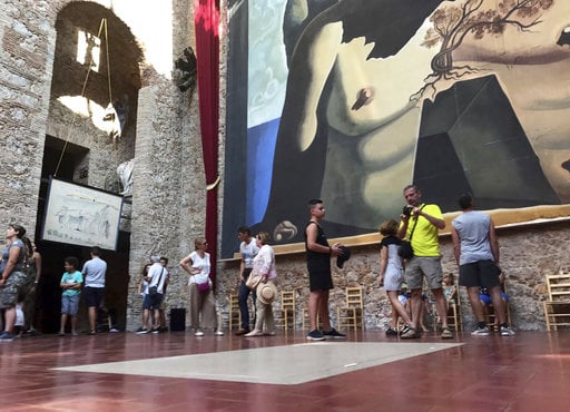 Visitors stand near the tomb of Salvador Dali inside Dali Museum Theatre in Figueres