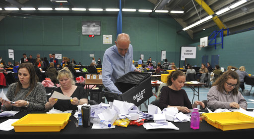 Election count staff tally ballot papers for the local election in Chelmsford