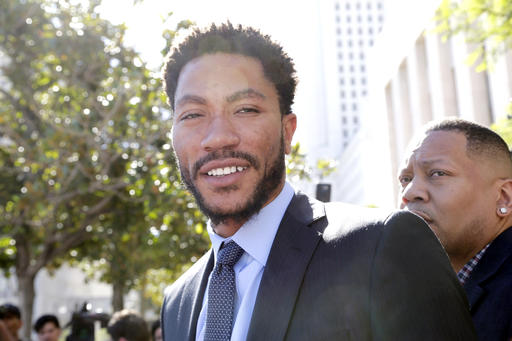 NBA star Derrick Rose smiles as he leaves federal court in Los Angeles Wednesday