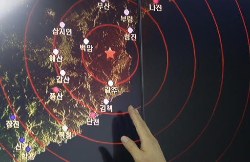 An official of the Earthquake and Volcano of the Korea Monitoring Division points at the epicenter of seismic waves in North Korea
