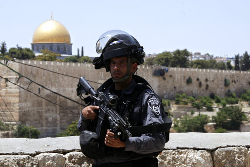 An Israeli border police officer stands guard outside in Jerusalem's Old City Friday