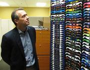 American Paper Optics President and CEO John Jerit looks at a display of solar eclipse glasses in Bartlett