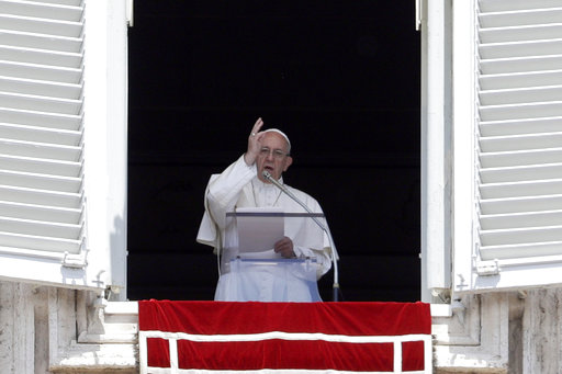 Pope Francis blesses faithful from his studio's window overlooking St. Peter's Square on the occasion of the Regina Coeli noon prayer at the Vatican