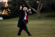 President Donald Trump waves as he walks on the South Lawn upon his return to the White House in Washington