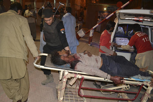 Pakistani volunteers rush an injured person to a hospital in Quetta