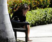 A woman weeps as she sits outside the Temple K'ol Tikvah before the funeral of Meadow Pollack