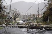 Electricity poles and lines lay toppled on the road after Hurricane Maria hit the eastern region of the island