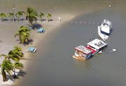 Boats are partially submerged in the wake of Hurricane Irma