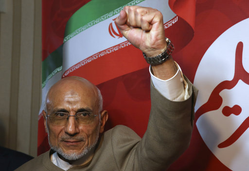 Conservative Iranian presidential candidate Mostafa Mirsalim clenches his fist at the conclusion of his news conference in Tehran
