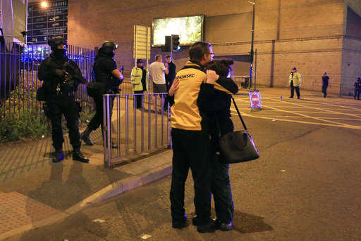 Armed police stand guard at Manchester Arena after reports of an explosion at the venue during an Ariana Grande gig  in Manchester