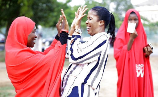 'Bring Back Our Girls' campaigners celebrate the release of the kidnapped Chibok school girls at the unity fountain in Abuja