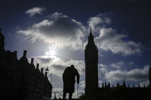 A statue of former British Prime Minister Winston Churchill silhouettes in front of the Houses of Parliament the day after Britain's national elections in London