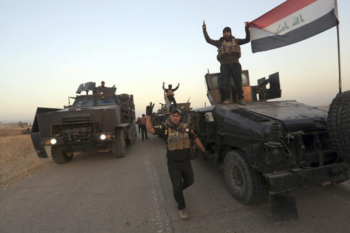 Members of Iraq's elite counterterrorism forces pose for a photo as they advance towards the city of Mosul
