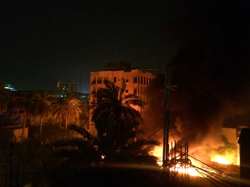 A fire erupts as smoke billows from the site of a car bomb