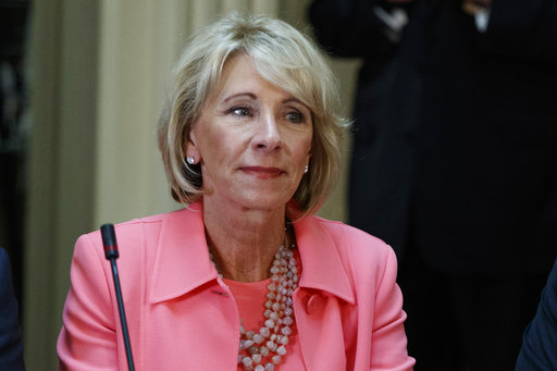 Education Secretary Betsy DeVos listens during a meeting between President Donald Trump and business leaders in the State Department Library of the Eisenhower Executive Office Building on the White House complex in Washington