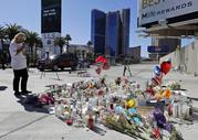 A woman looks over a makeshift memorial site on Las Vegas Boulevard on Tuesday