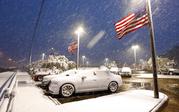 American flags wave as snow falls