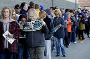 People wait in line for a Best Buy store to open for a Black Friday sale on Thanksgiving Day