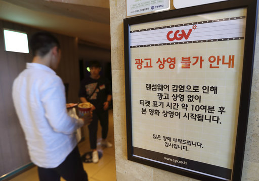 A customer walks by the notice about "ransomware" at CGV theater in Seoul