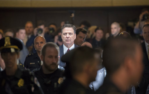 Former FBI director James Comey walks through a corridor on the way to a secure room to continue his testimony to the Senate Select Committee on Intelligence