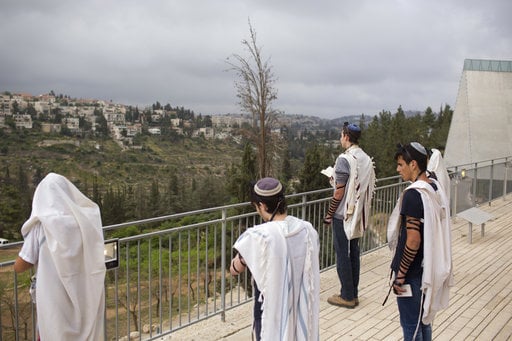 Visitors pray before their tour at the Yad Vashem Holocaust Memorial in Jerusalem