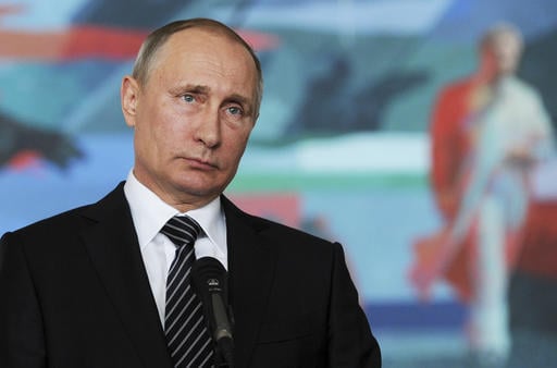 Russian President Vladimir Putin listens to a journalist's question during a news conference after a CIS (Commonwealth of Independent States