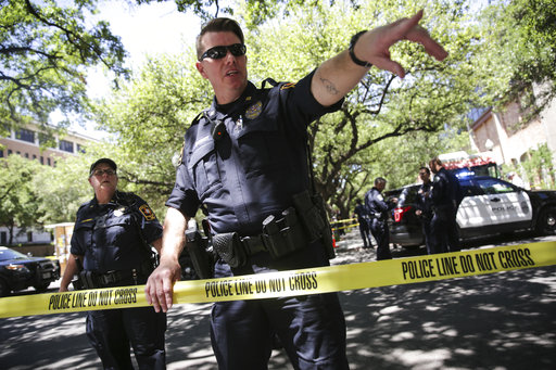 Law enforcement officers secure the scene after a fatal stabbing attack on the University of Texas campus Monday