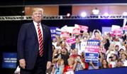 President Donald Trump stands before speaking at a rally at the Phoenix Convention Center