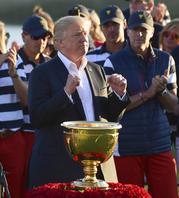 President Donald Trump participates in presenting the Presidents Cup to the United States team at the Jersey City Golf Club in Jersey City