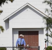 A law enforcement official leaves the First Baptist Church Tuesday