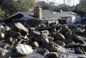 Large rocks and mud are shown in front of a house in Montecito