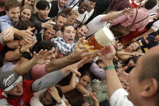 People fight for free beer during the opening ceremony of the 183rd Oktoberfest beer festival in Munich