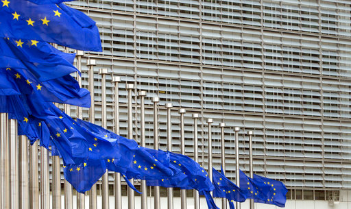 European Union flags blow in the wind at half-staff outside EU headquarters in Brussels on Tuesday
