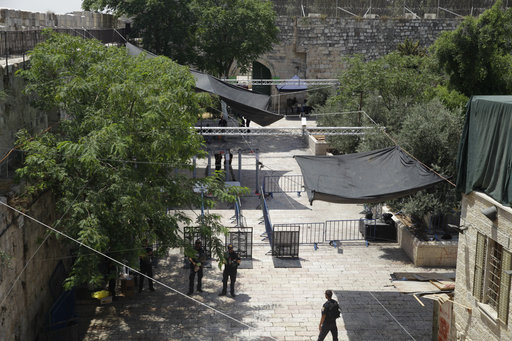 Israeli border police officers stand guard near newly installed cameras at the entrance to the Al Aqsa Mosque compound in Jerusalem's Old City